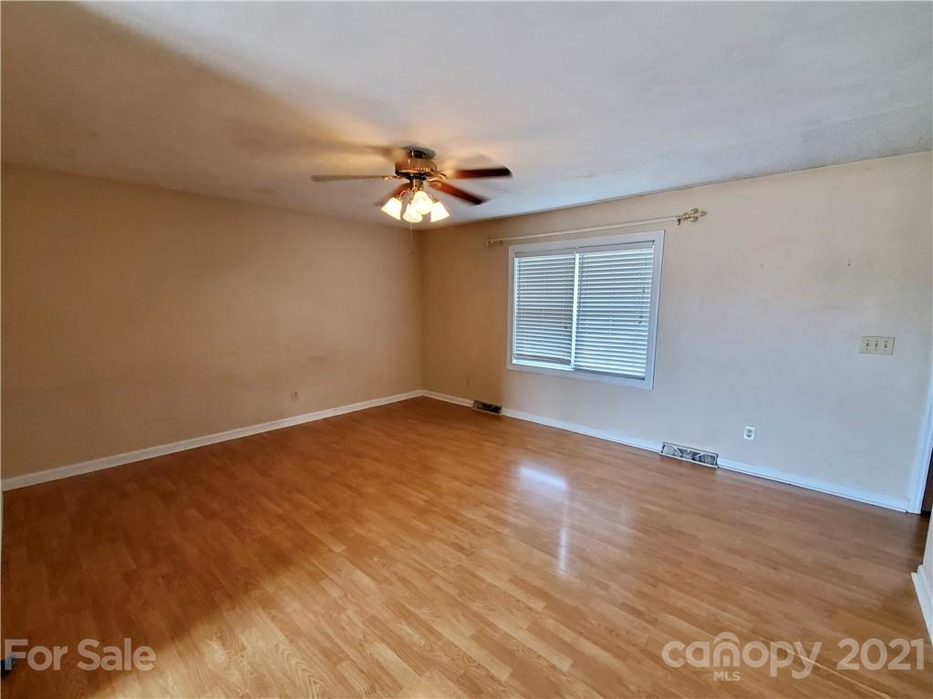 175 Old Airport Road Statesville, NC 28677 - Photo 2 of 15 an empty room with windows and chandelier fan