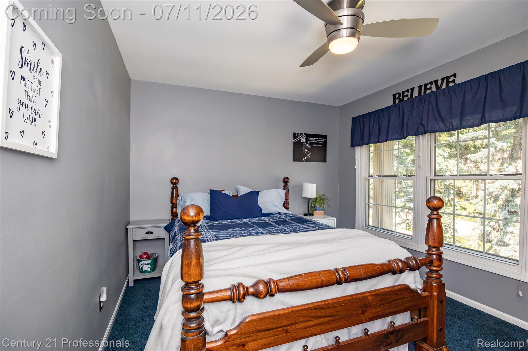 689 Woodfield Way Rochester, MI 48307 - Photo 36 of 61 Bedroom with a ceiling fan, two large windows, grey walls, and blue carpeting