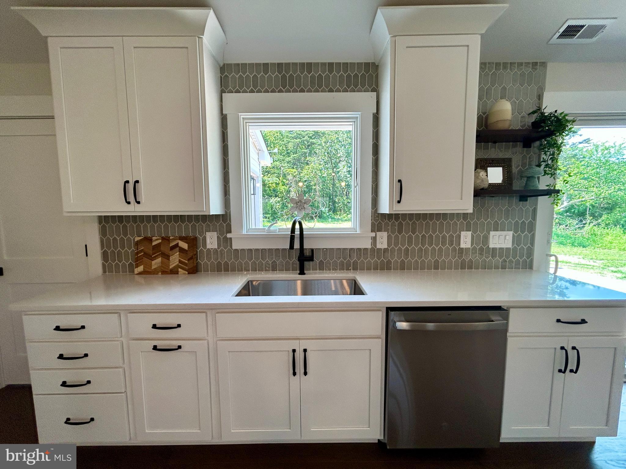 210 Perry Road Woodbine, NJ 08270 - Photo 13 of 35 a kitchen with white cabinets and sink