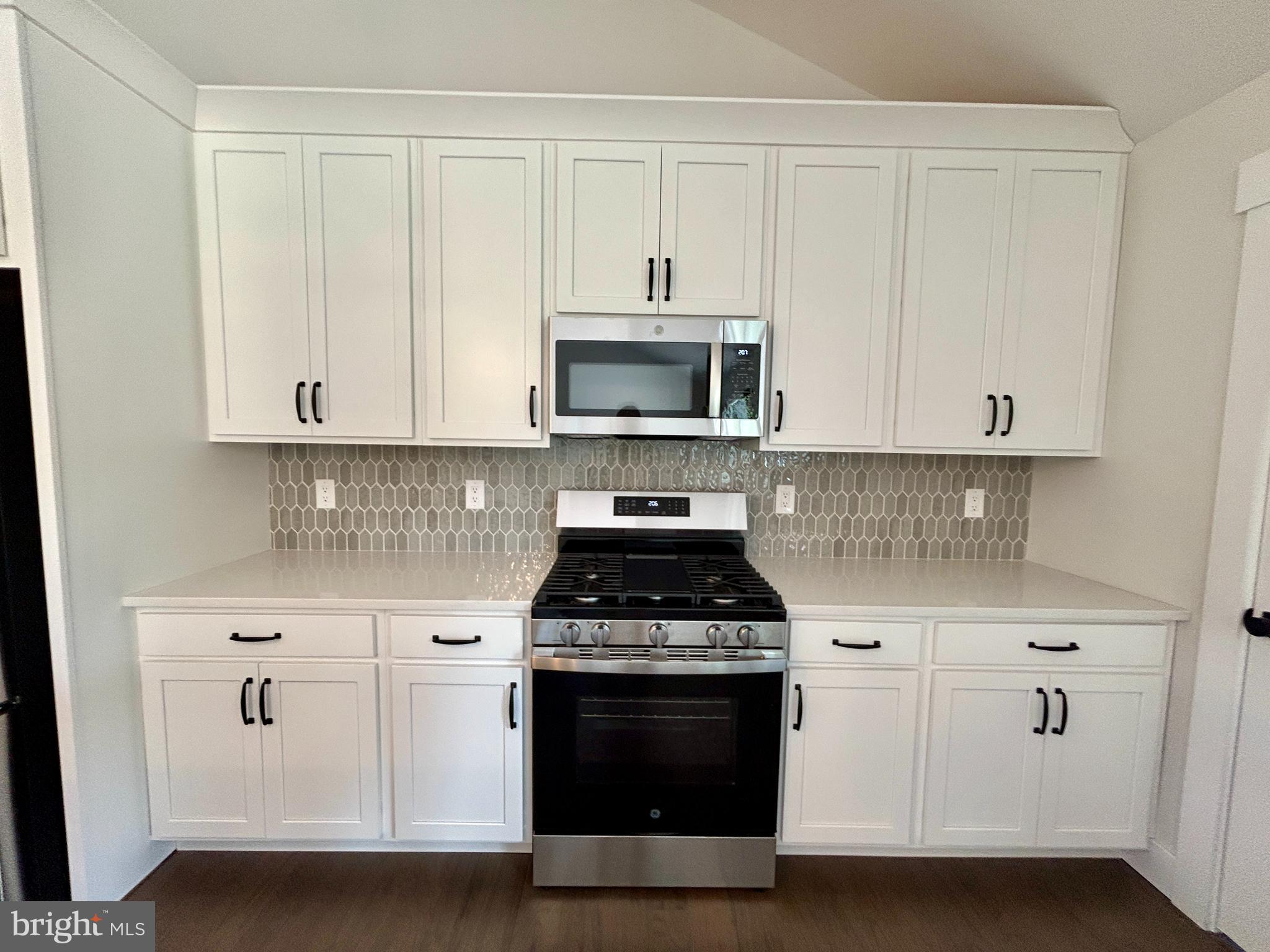210 Perry Road Woodbine, NJ 08270 - Photo 14 of 35 a kitchen with white cabinets and stainless steel appliances