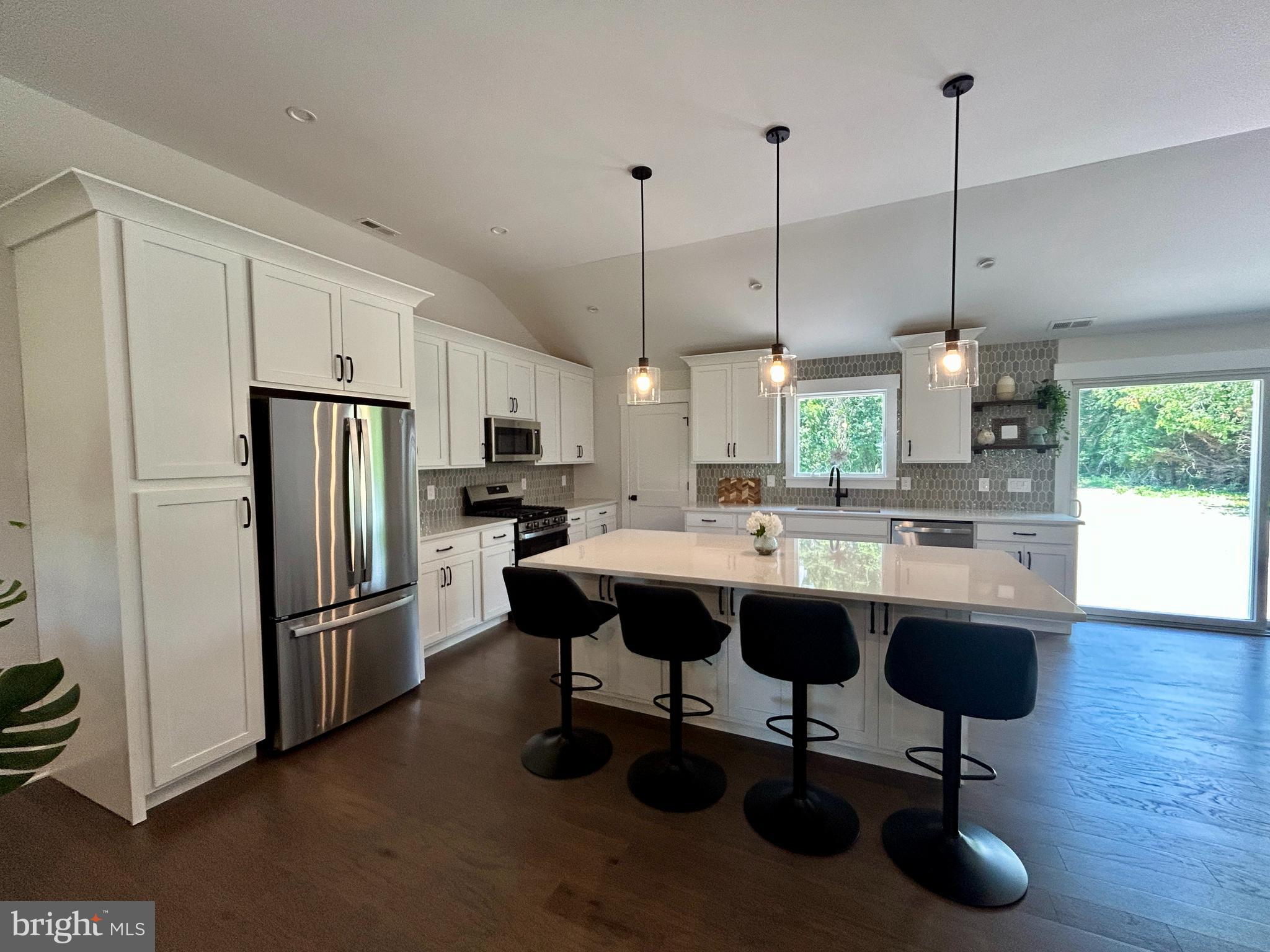 210 Perry Road Woodbine, NJ 08270 - Photo 16 of 35 a kitchen with stainless steel appliances granite countertop a refrigerator a sink dishwasher a dining table chairs and stove