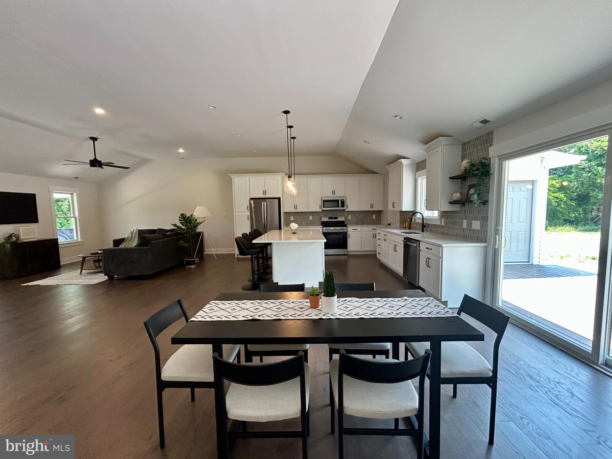 210 Perry Road Woodbine, NJ 08270 - Photo 21 of 35 a kitchen with a dining table chairs and refrigerator