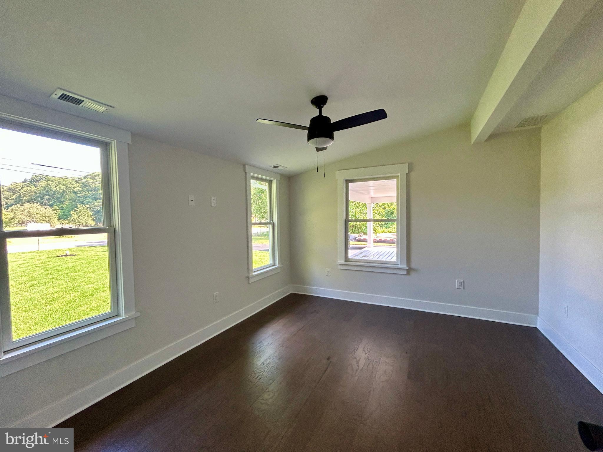 210 Perry Road Woodbine, NJ 08270 - Photo 31 of 35 a view of an empty room with wooden floor and a window