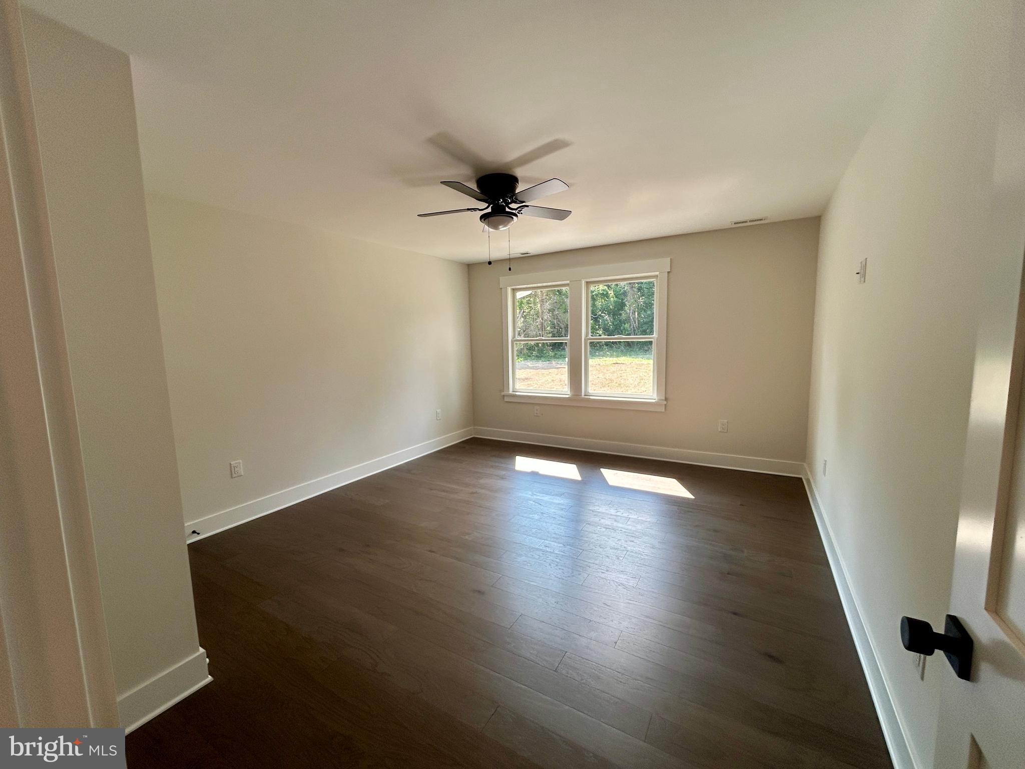 210 Perry Road Woodbine, NJ 08270 - Photo 33 of 35 an empty room with wooden floor and windows