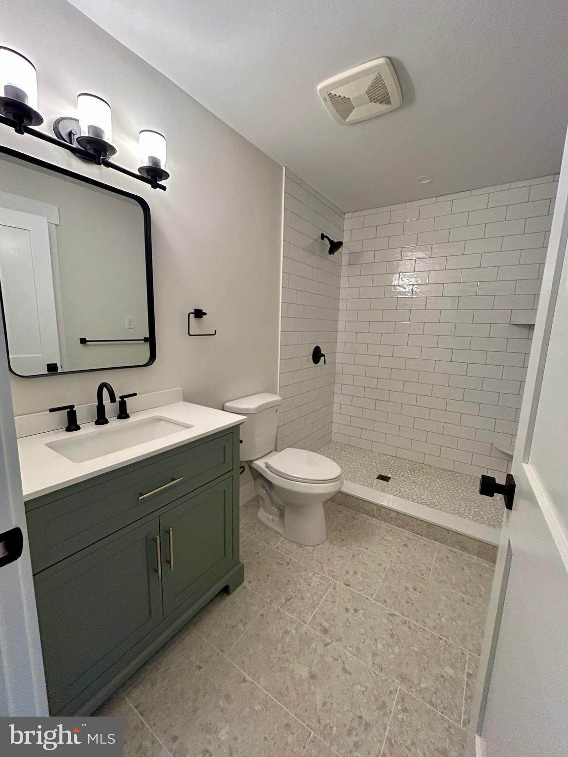 210 Perry Road Woodbine, NJ 08270 - Photo 34 of 35 a bathroom with a double vanity sink toilet mirror and shower