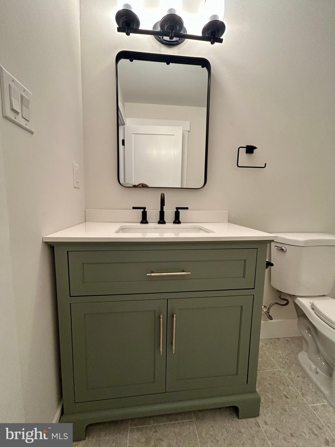 210 Perry Road Woodbine, NJ 08270 - Photo 35 of 35 a bathroom with a toilet sink and mirror