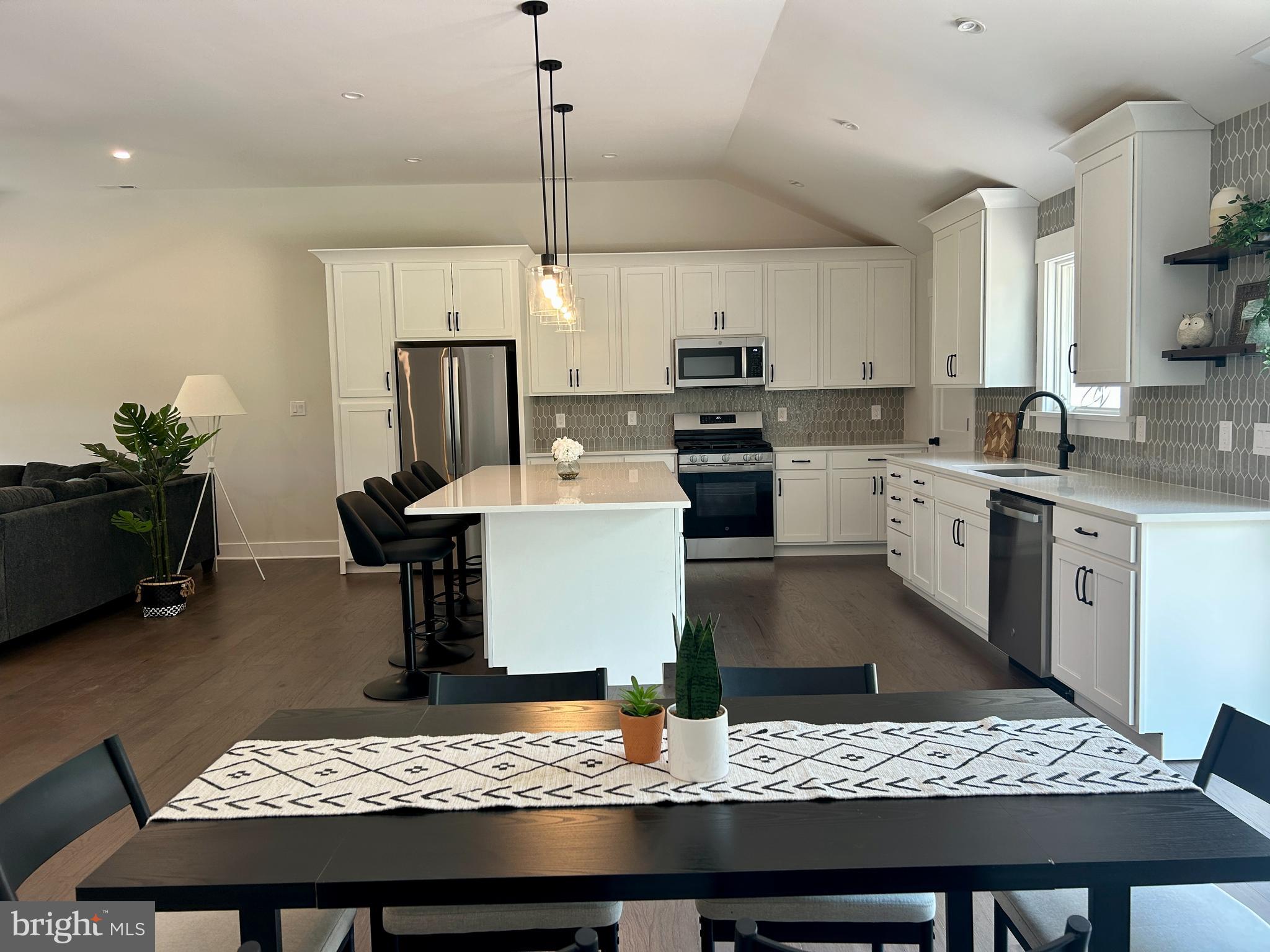 210 Perry Road Woodbine, NJ 08270 - Photo 8 of 35 a kitchen with a stove a sink dishwasher a kitchen island a table and chairs