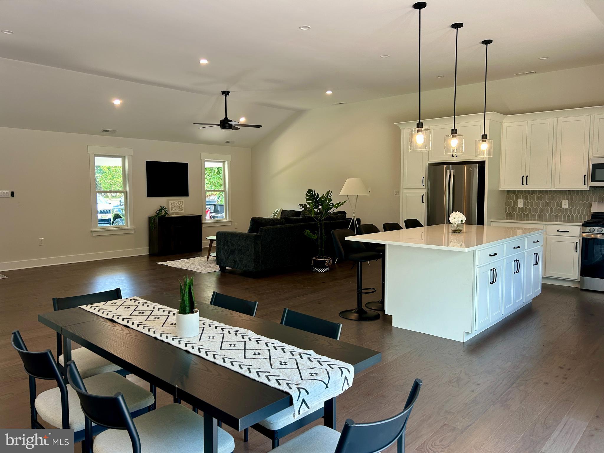 210 Perry Road Woodbine, NJ 08270 - Photo 9 of 35 a living room with furniture a chandelier and a flat screen tv