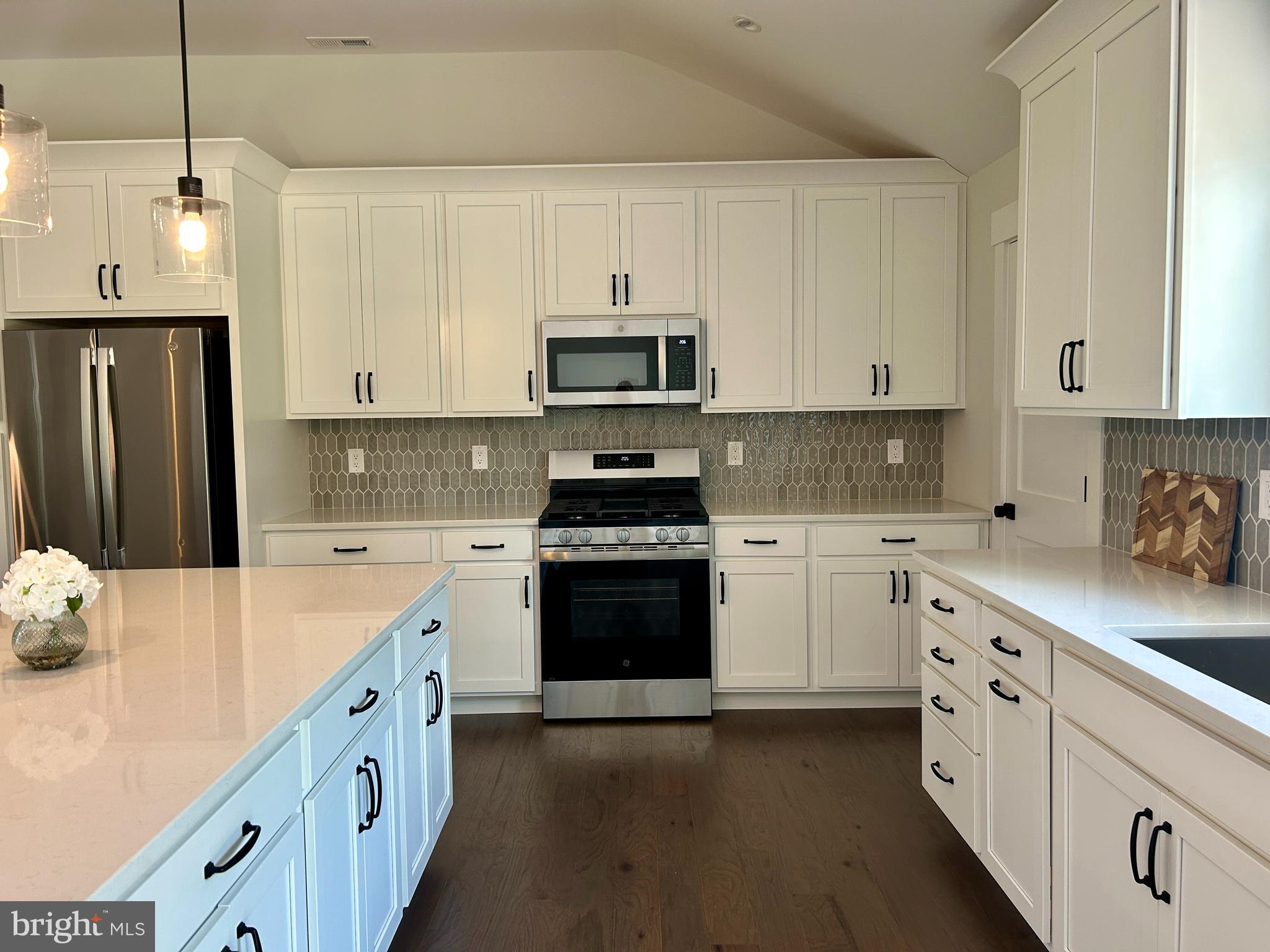 210 Perry Road Woodbine, NJ 08270 - Photo 10 of 35 a kitchen with granite countertop white cabinets and stainless steel appliances