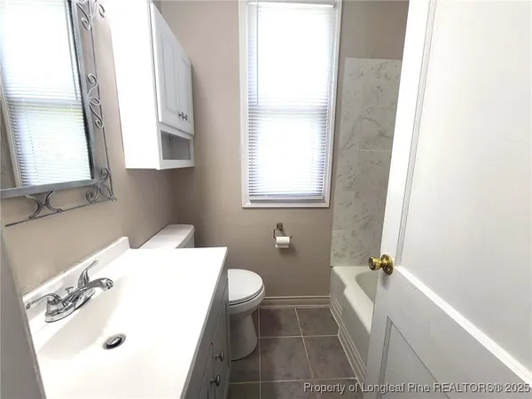 a bathroom with a sink toilet and tub
