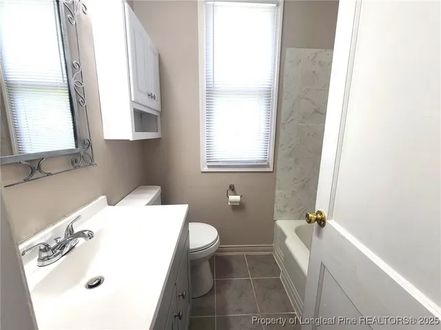 a bathroom with a sink toilet and tub