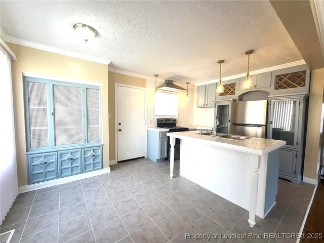 a large kitchen with cabinets and stainless steel appliances