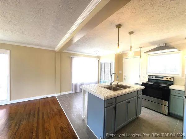 a kitchen with a sink stove and microwave