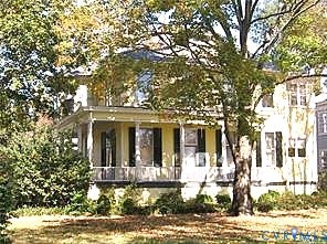 243 South Adams Street Petersburg, VA 23803 - Photo 2 of 8 a view of a brick house with large windows and a tree