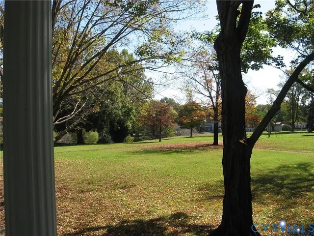 a view of a field with an trees in the background