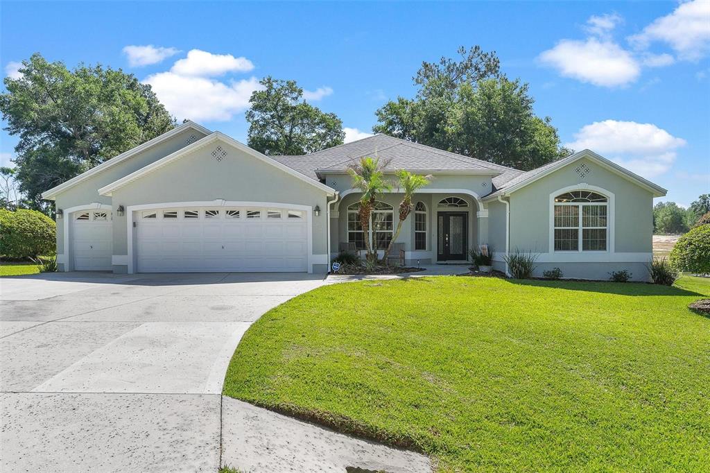 1027 Urico Road Lady Lake, FL 32159 - Photo 1 of 49 a front view of a house with a garden