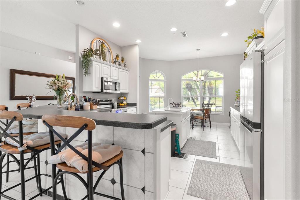 1027 Urico Road Lady Lake, FL 32159 - Photo 12 of 49 a large kitchen with a table and chairs