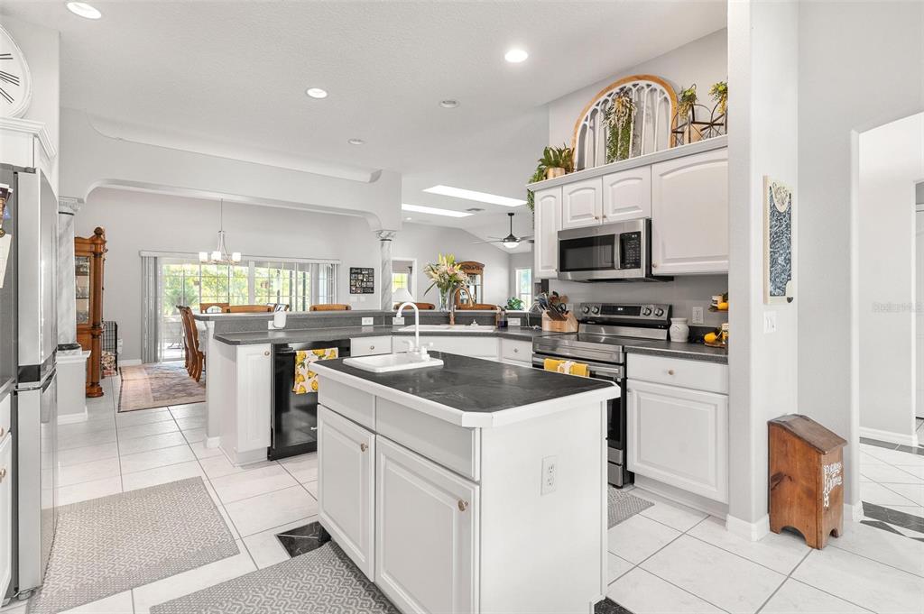 1027 Urico Road Lady Lake, FL 32159 - Photo 14 of 49 a kitchen with counter top space appliances and cabinets