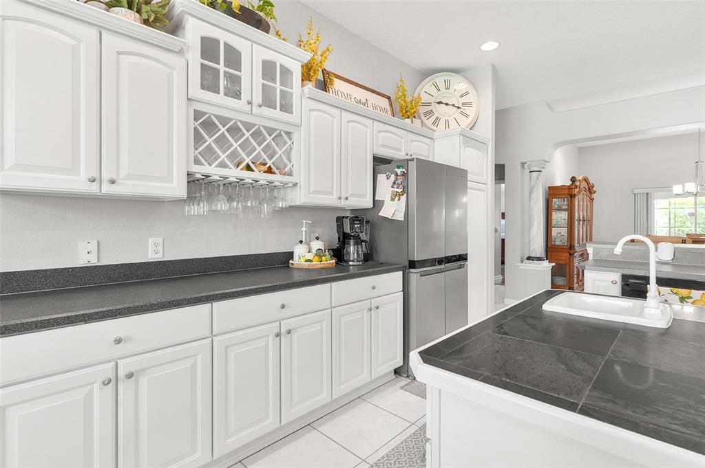 1027 Urico Road Lady Lake, FL 32159 - Photo 17 of 49 a kitchen with stainless steel appliances granite countertop a sink and cabinets