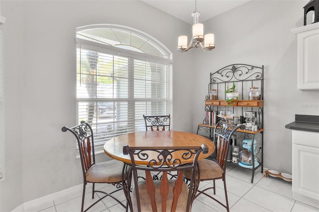1027 Urico Road Lady Lake, FL 32159 - Photo 19 of 49 a view of a dining room with furniture and chandelier