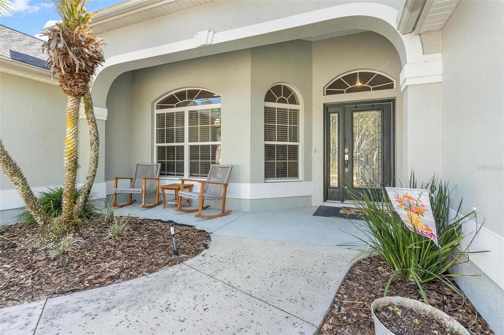 1027 Urico Road Lady Lake, FL 32159 - Photo 2 of 49 a front view of a house with garden