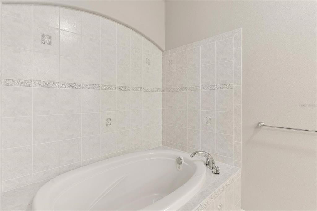 1027 Urico Road Lady Lake, FL 32159 - Photo 22 of 49 a white bath tub sitting next to a white sink and vanity