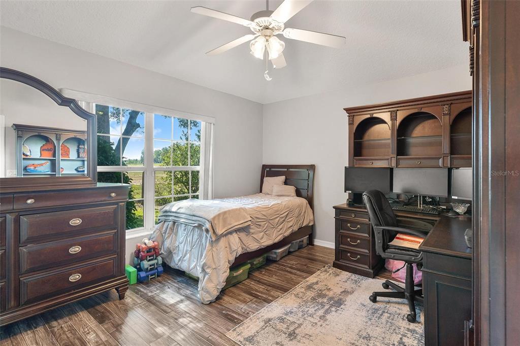 1027 Urico Road Lady Lake, FL 32159 - Photo 27 of 49 a bedroom with a bed and a dresser