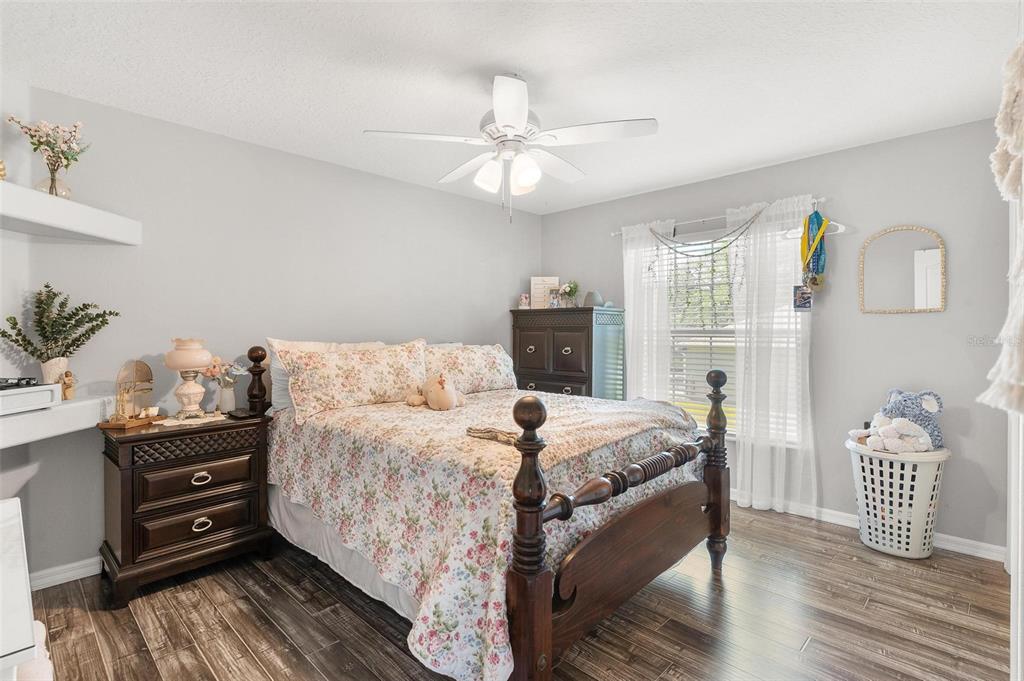 1027 Urico Road Lady Lake, FL 32159 - Photo 31 of 49 a bed room with a bed and a chandelier