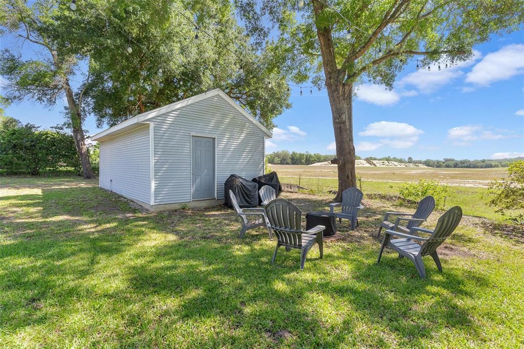 1027 Urico Road Lady Lake, FL 32159 - Photo 40 of 49 a backyard of a house with table and chairs