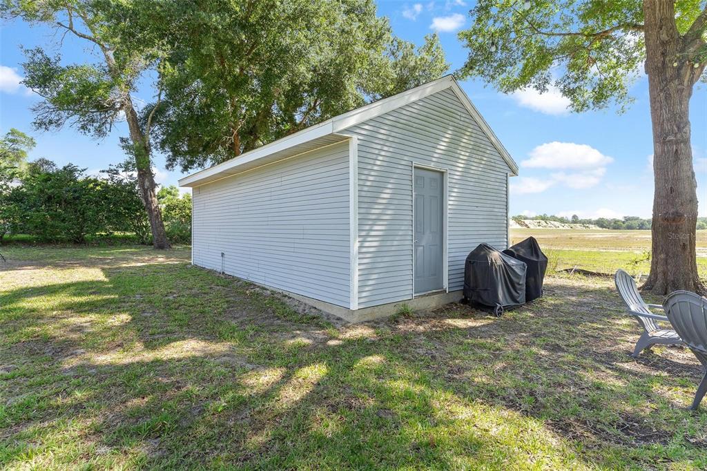 1027 Urico Road Lady Lake, FL 32159 - Photo 41 of 49 a view of a house with backyard and garden
