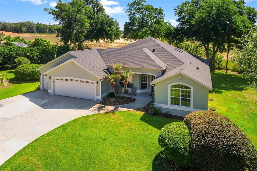 1027 Urico Road Lady Lake, FL 32159 - Photo 46 of 49 a view of a house with garden and a yard