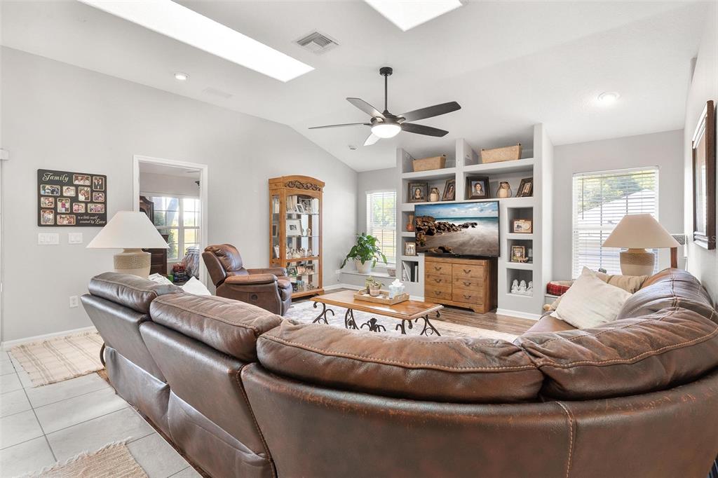1027 Urico Road Lady Lake, FL 32159 - Photo 6 of 49 a living room with furniture and a flat screen tv
