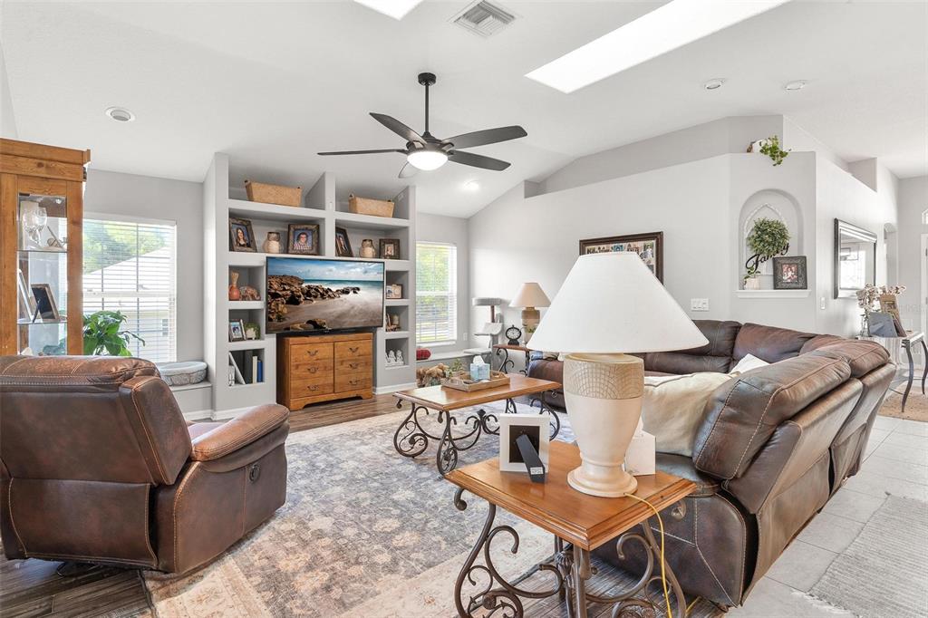 1027 Urico Road Lady Lake, FL 32159 - Photo 7 of 49 a living room with furniture a rug and a chandelier