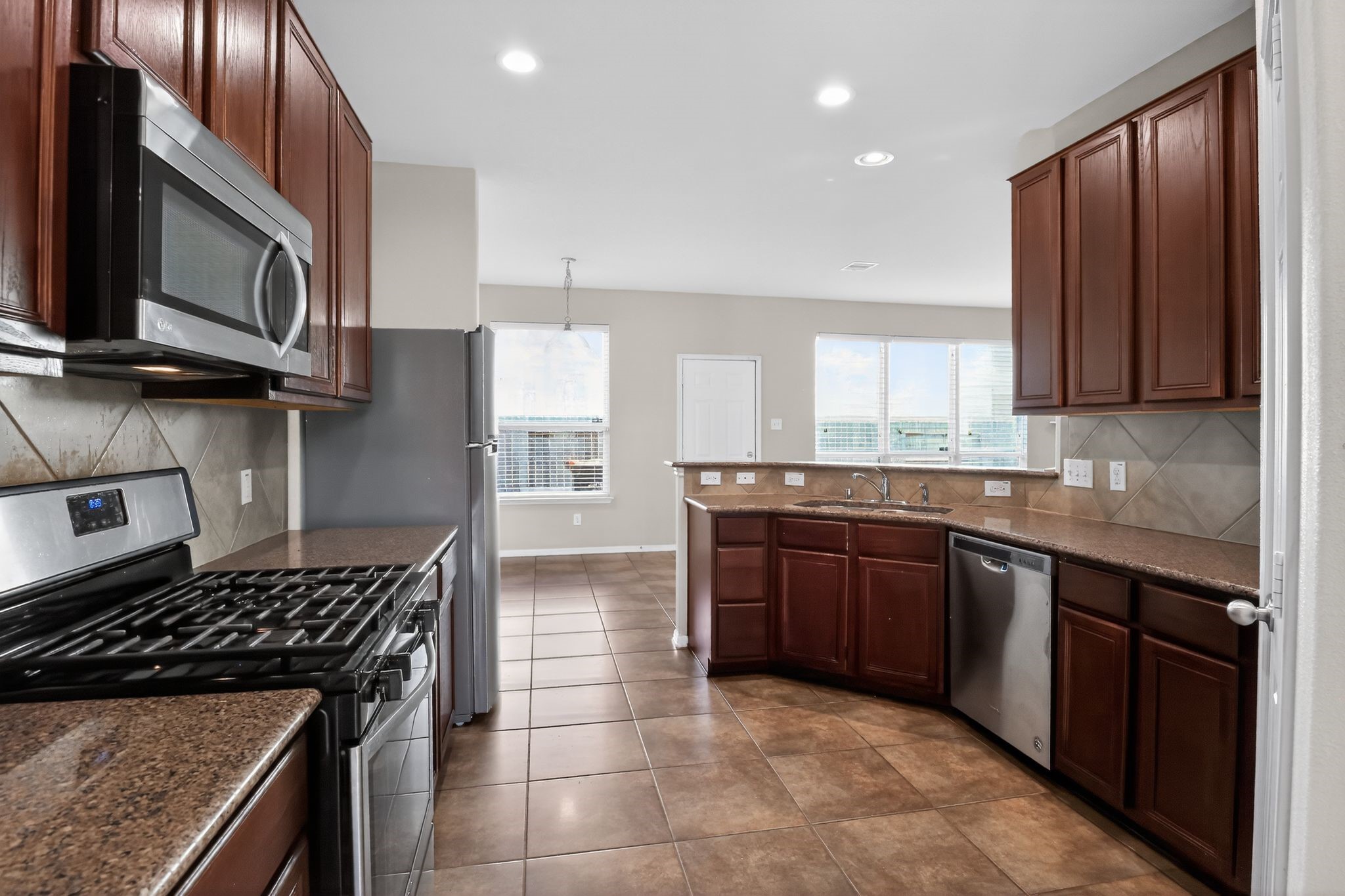 a kitchen with a sink a stove and cabinets