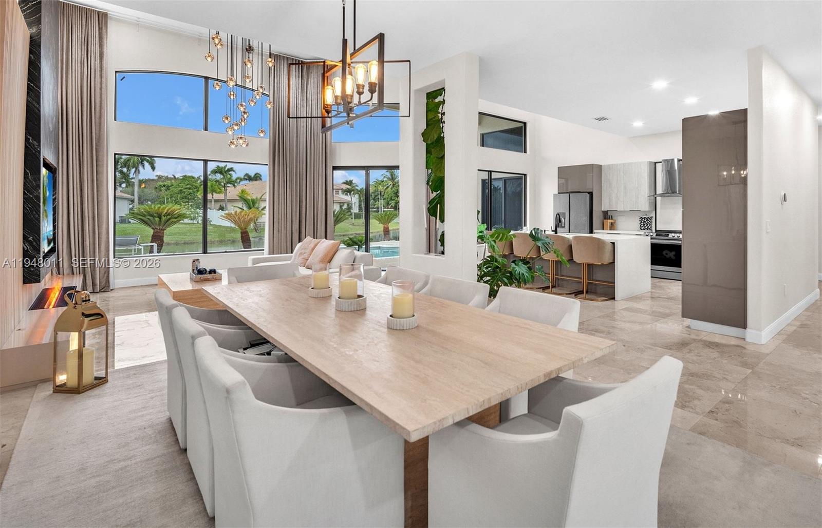 3586 Southwest 143rd Avenue Miramar, FL 33027 - Photo 13 of 51 a kitchen with stainless steel appliances kitchen island granite countertop a table and chairs