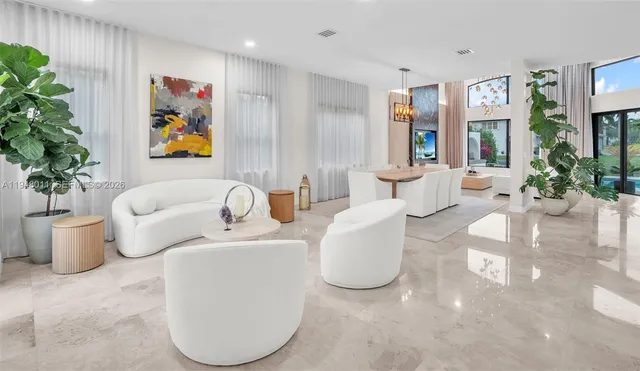 a living room with furniture and flowers