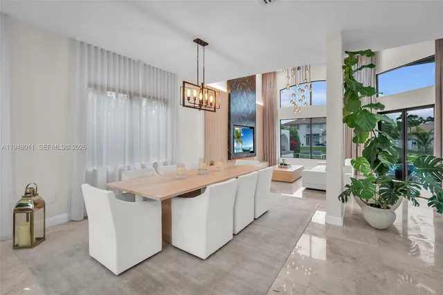 a large living room with stainless steel appliances kitchen island granite countertop furniture and a potted plant