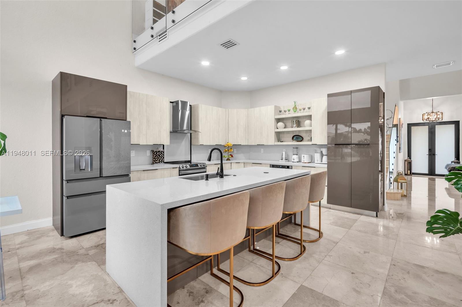 3586 Southwest 143rd Avenue Miramar, FL 33027 - Photo 19 of 51 a kitchen with refrigerator and chairs