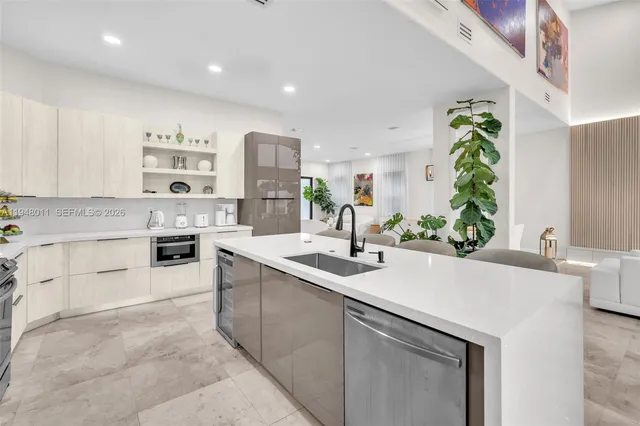 a kitchen with refrigerator and chairs