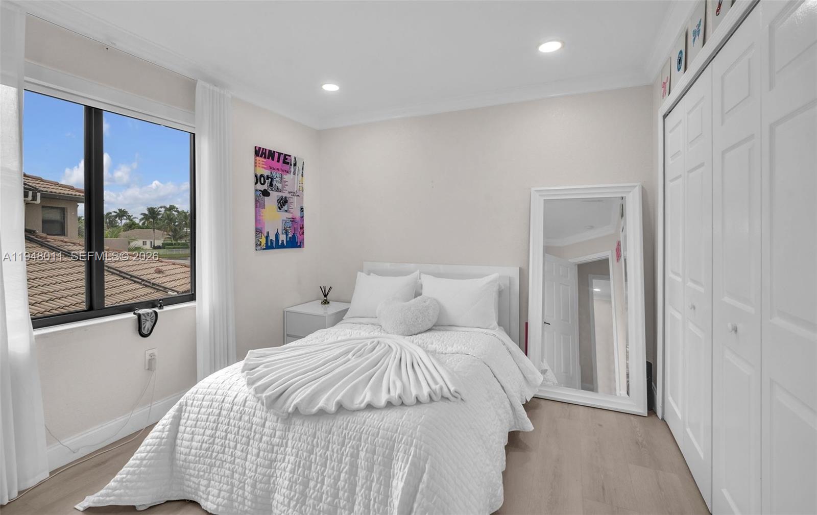 3586 Southwest 143rd Avenue Miramar, FL 33027 - Photo 34 of 51 a bedroom with a large bed and a large window