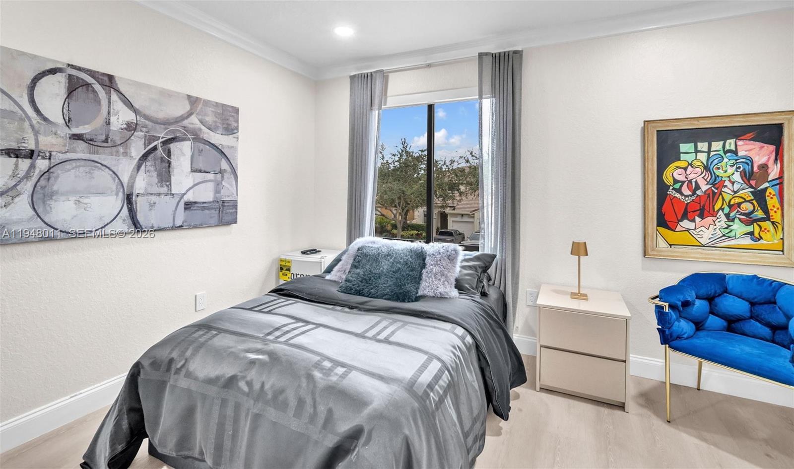 3586 Southwest 143rd Avenue Miramar, FL 33027 - Photo 37 of 51 a bedroom with a bed and a painting on the wall