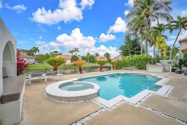 a swimming pool with outdoor seating yard and barbeque oven