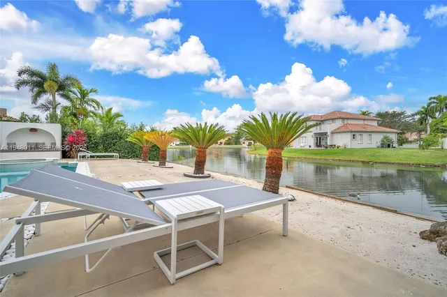 a front view of a house with outdoor space and swimming pool