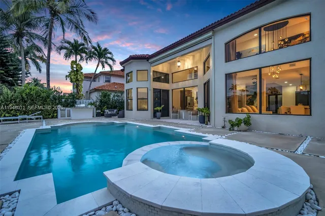 a front view of a house with a garden and yard