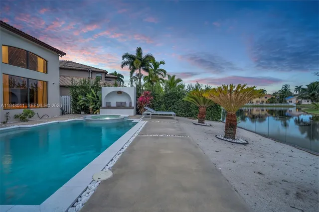 a front view of multi story residential apartment building with yard and sign board