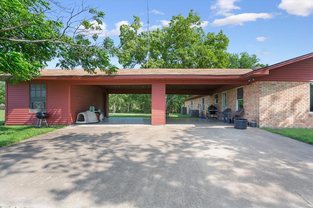 221 County Road 157 Riesel, TX 76682 - Photo 27 of 30 View of parking featuring an attached carport and driveway