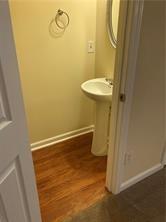 4332 Park Gate Way, Unit 175 Atlanta, GA 30344 - Photo 12 of 12 a bathroom with a granite countertop sink and a mirror