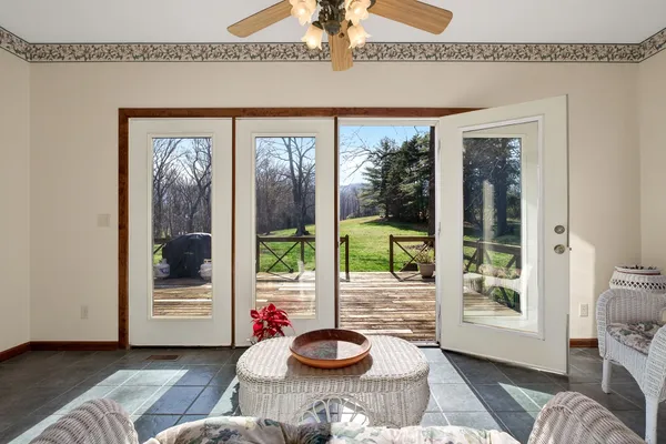 a bedroom with a bed a mirror and a window