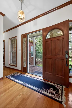 a view of a room with wooden floor and windows
