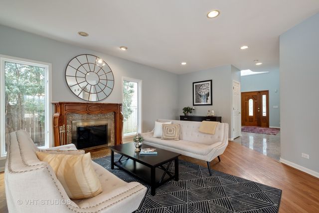a living room with furniture a table and a fireplace